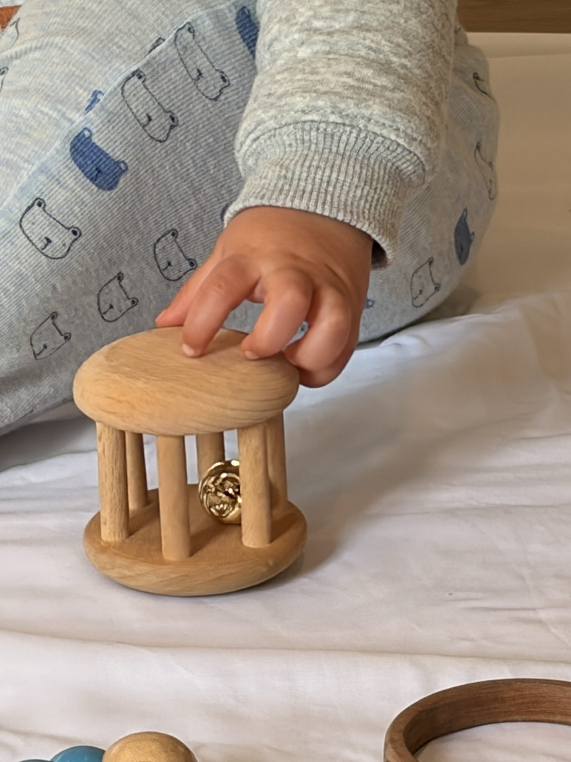 parent and me class picture of baby playing with a wooden toy