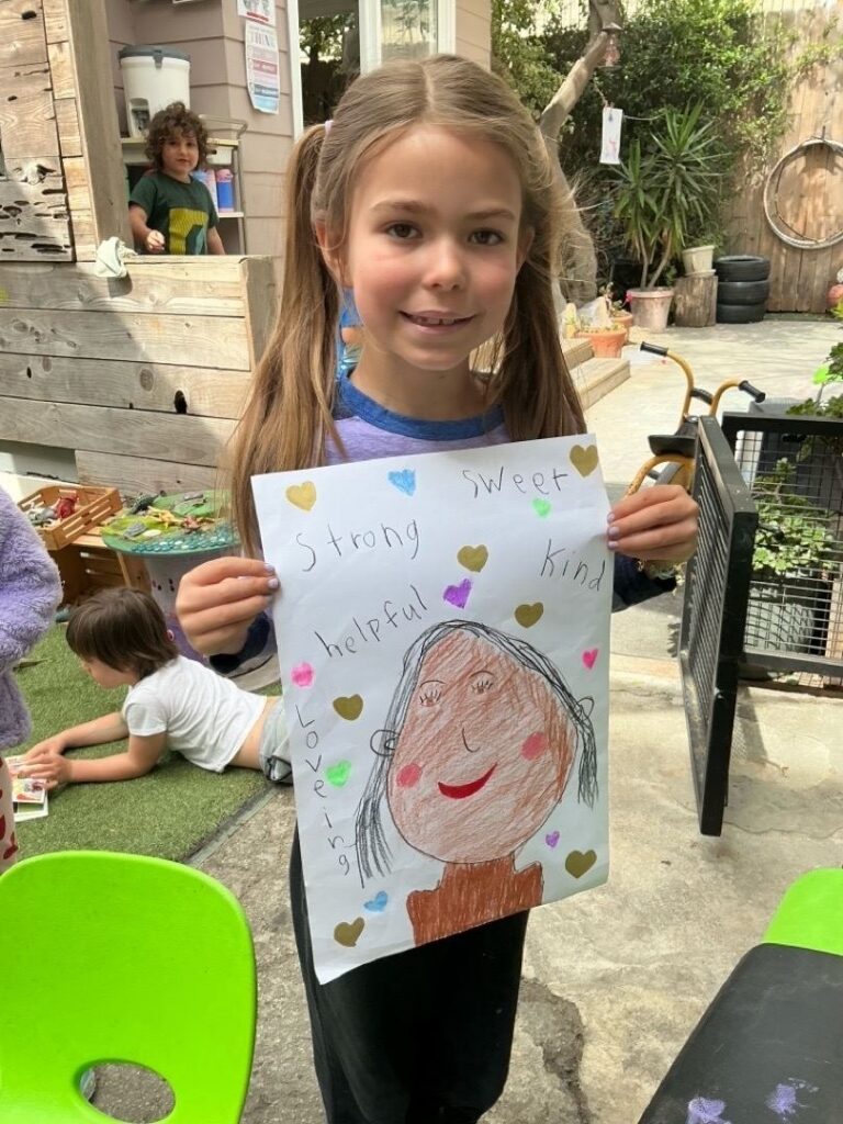 child at jewish preschool west LA with art project